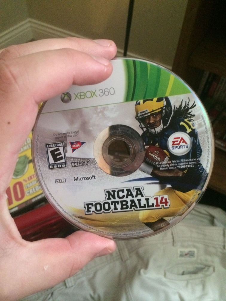 Ron Davis holds a copy of NCAA Football 14 in his apartment on Saturday, April 11th, 2015 in Columbia, Mo. Although Davis loves playing this particular game, he is very displeased that the NCAA Football series has discontinued.